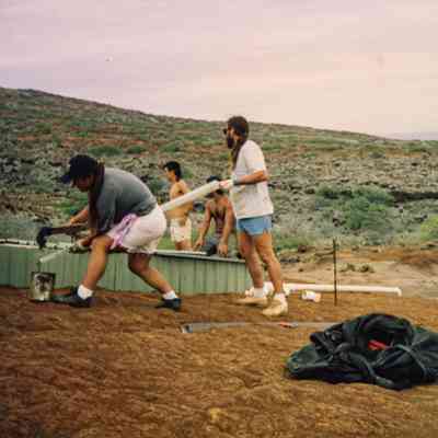 People working on a water catchment structure