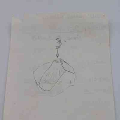 Back of artifact slip: The image depicts an artifact slip with a hand-drawn illustration indicating details or structure, and some faint handwriting.