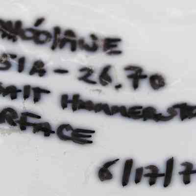 Artifact bag label for a basalt hammerstone: The image shows a label with handwritten text reading “KAHO'OLAWE,” followed by numbers “251A - 26.70.”