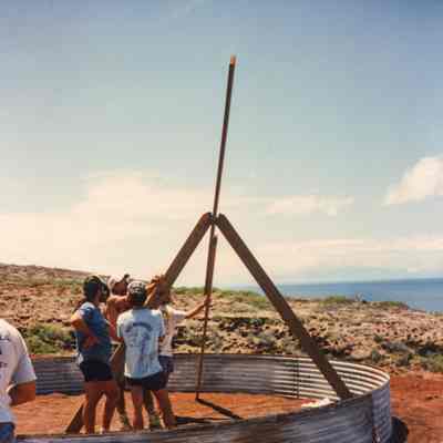 Men hoisting wooden structure