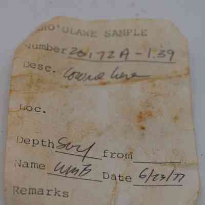 Artifact slip of cowrie shell lure: The image shows an aged artifact slip labeled "Kaho’olawe Sample" with details such as number, description, depth, name, and the date recovered.