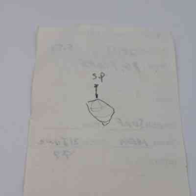 Back of artifact slip for basaltic glass flake: The image shows an artifact slip with faded text and a simple sketch of a basaltic glass flake.