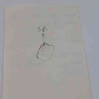 Back of artifact slip: The image shows an artifact slip with a hand-drawn sketch and notes, featuring labels including "SP" and an arrow pointing to a shape.