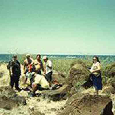 A group of people near pohaku (rocks)