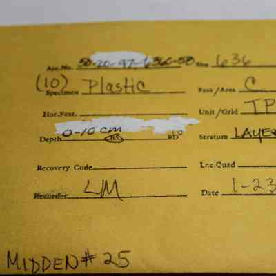 Manila artifact envelope for plastic pieces: The yellow card details archaeological specimen information, including plastic material from Layer I.