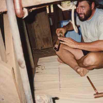 Dan Holmes sitting and installing pipe