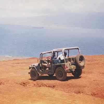 Two people sitting in jeep