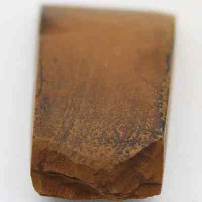 Lengthwise view of basalt adze (ko'i): The image displays a stone adze (ko'i) head with a smooth, flat surface and slightly tapered edges, suggesting its use for shaping materials.