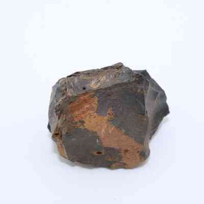 Closeup of basaltic glass core: The image shows a rough, dark basaltic glass core with a combination of smooth and jagged surfaces, highlighting its volcanic origin.