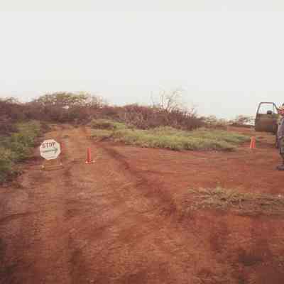 Part of dirt road with stop sign