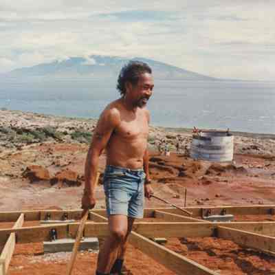 A man holding a wooden handles at a wooden frame
