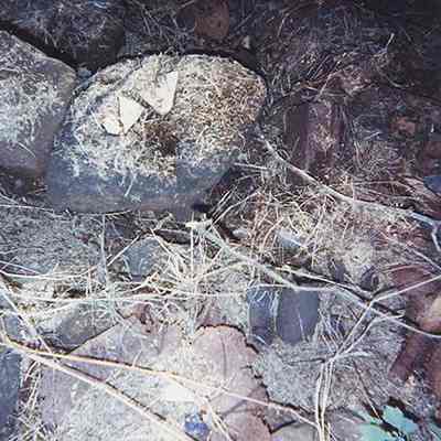 Scatter of porcelain shards, metal object and lithics