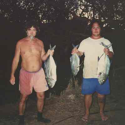 Two men holding fish