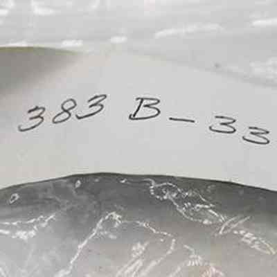 Bag label for a hammerstone: The image shows a handwritten label with the text "20 383 B-33.32" attached to a clear plastic bag.