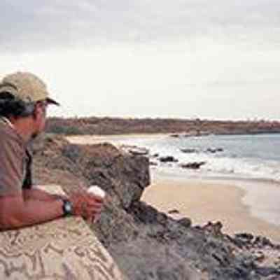 Unidentified man looking at an excavator