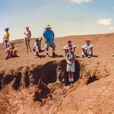 People sitting and standing on hardpan
