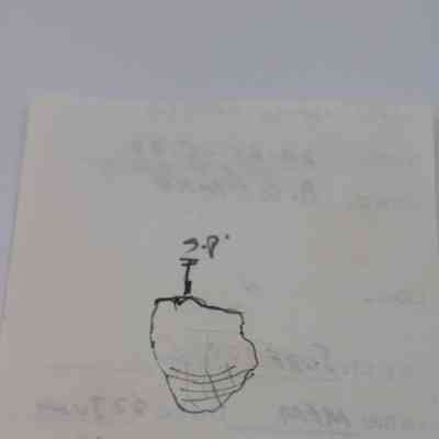Back of artifact slip (KIRC Object ID #2015.006.119): The image shows the back of an artifact slip with a rough sketch and faint handwritten notes, indicating details about the artifact.