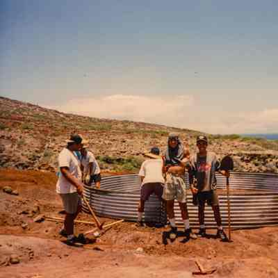 People working on metal water catchment