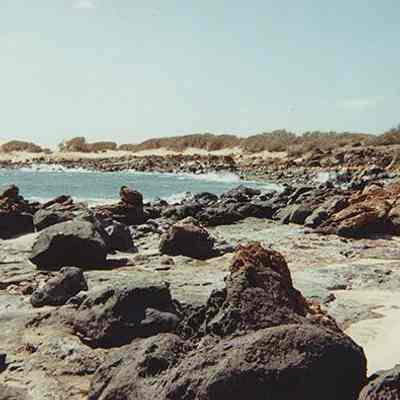 Rocky coastline and white sand beach