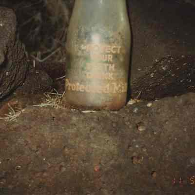 The bottom part of an old milk bottle