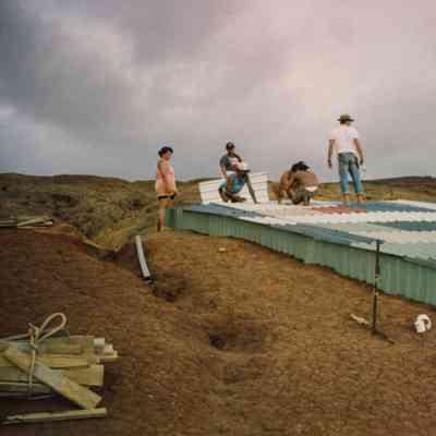 People working on a water catchment structure