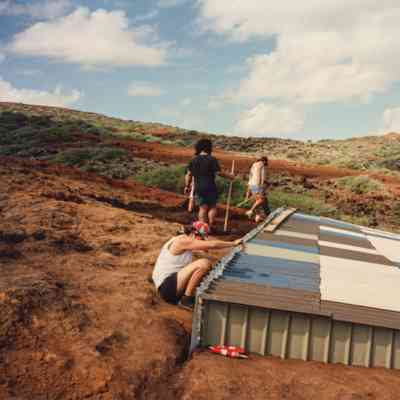 People working on and around water catchment structure