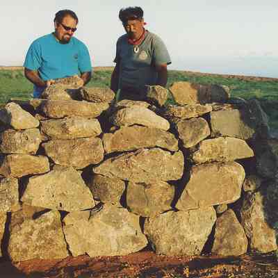 Two men building rain ko'a