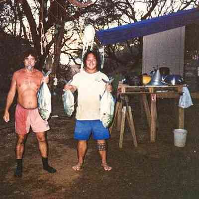 Two men holding fish