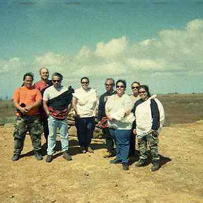 Group of people in front of rain ko'a (shrine)