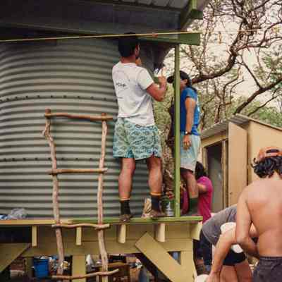 Several people working on and near water storage structure