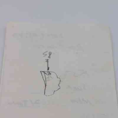 Back of artifact slip for basaltic glass flake: The image features a slip with handwritten notes and a simple diagram sketch.