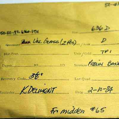 Artifact envelope for volcanic glass: The image shows a labeled manila envelope used for archiving specimens, with handwritten details such as the date, recorder's name, and depth.