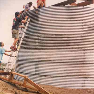 People working on water catchment structure