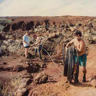 People laying out irrigation line