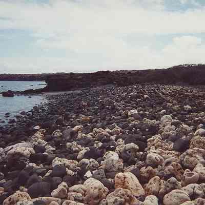 White coral & black rock along shoreline