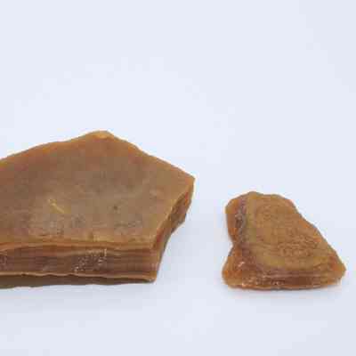Two agate flakes: The image shows two agate flakes of brownish color, with layered textures visible, displayed against a plain white background.