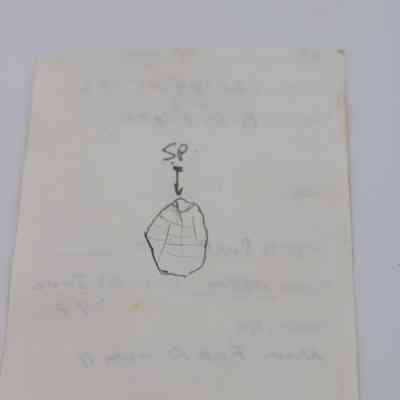 Back of artifact slip (KIRC Object ID #2015.006.140): The image shows an artifact slip featuring a detailed illustration and faint handwriting, documenting specific findings or observations.