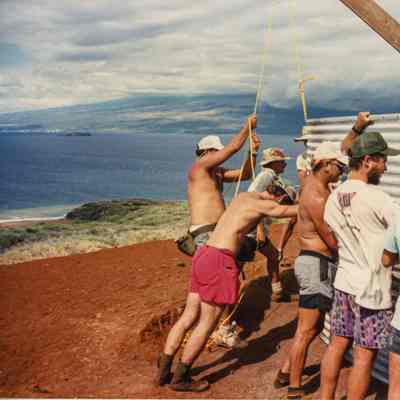 Group of men assembling corrugated metal walls