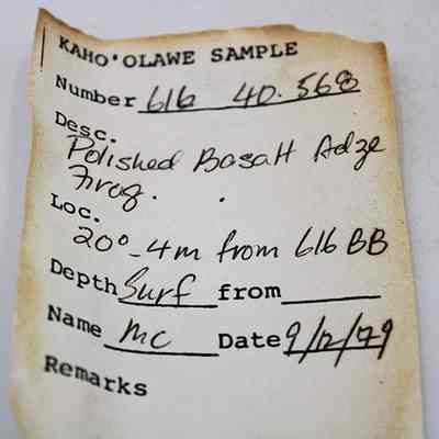 Artifact slip for a polished basalt adze (ko'i) fragment: The image shows a weathered artifact slip with sample details, including a polished basalt adze fragment description from Kaho'olawe, dated September 12, 1979.
