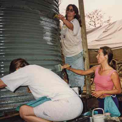 Women painting water storage tank