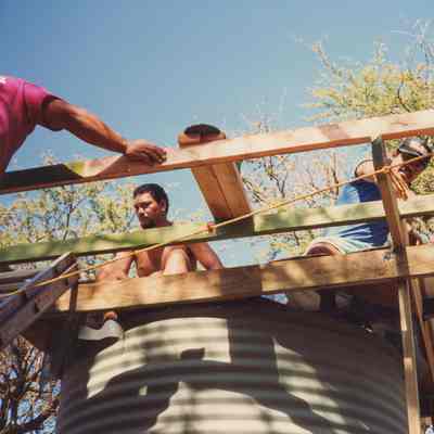 Men working on top of a water storage structure