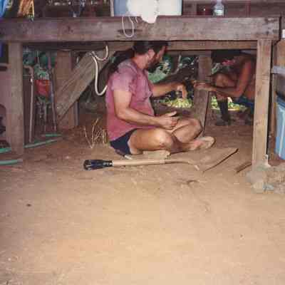 Two men working on wooden base of table
