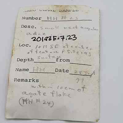 Artifact slip for small rectangular adze: The image shows a sample tag with details, including a sample number, description, location, depth, name, date, and remarks.