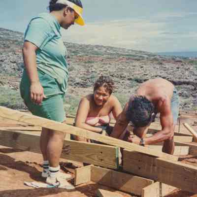 People working on wooden frame