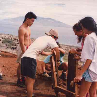 People working on wooden frame