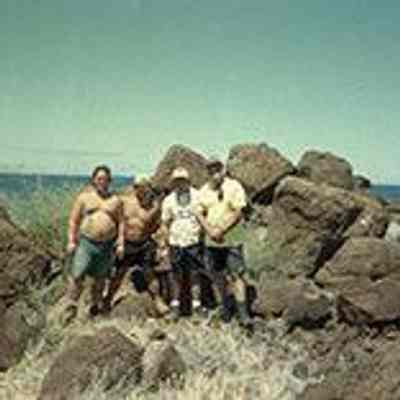 A group of men near pohaku (rocks)