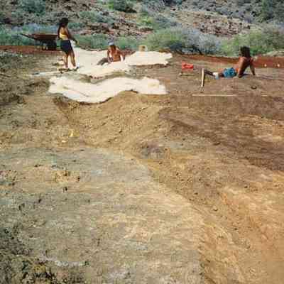 People at hardpan erosion site