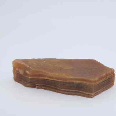 Two agate flakes: The image shows two brownish agate flakes with fine layered patterns, resting against a plain white background.