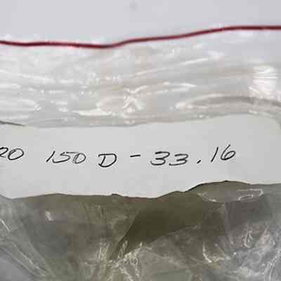 Bag label for grindstone: The image shows a transparent plastic bag with a red zip seal, containing a label marked "20 150 D -33,16" written in pencil.