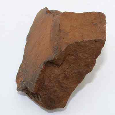 Whetstone (hoana) fragment: The image shows a rugged, brown fragment of a whetstone (hoana) with uneven surfaces, possibly used for sharpening tools in the past.